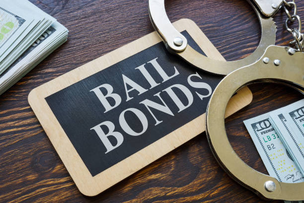 Handcuffs lying next to a sign that reads "Bail Bonds," symbolizing arrest and release services.
